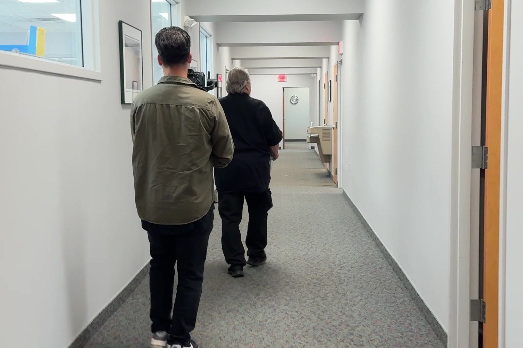 Our crew walking down a long office hallway toward a shoot