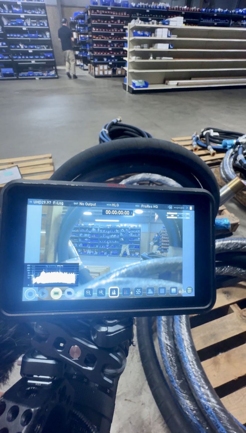Camera monitor on a rig in a store aisle